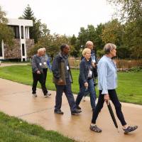 Overview photo of the class of '68 walking on campus near Lake Michigan Hall.